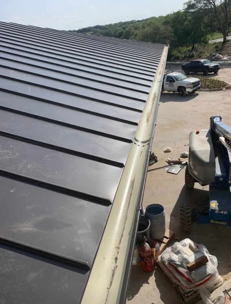 Standing seam panel and gutter detail on a metal roofing jobsite in Fruitvale